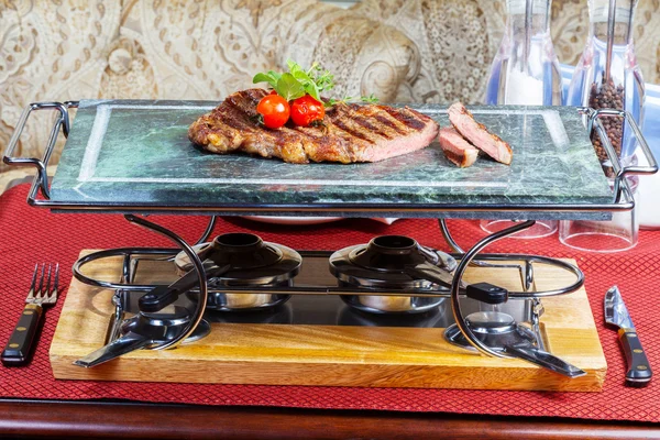 Preparação de carne grelhada com tomates em uma bandeja de mármore — Fotografia de Stock