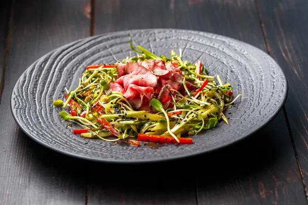 Salada autêntica com bacon pimenta vermelha fresca, brotos, gergelim e — Fotografia de Stock