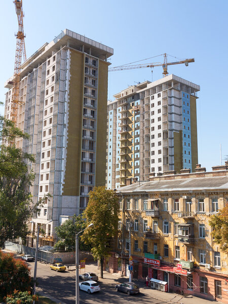 ODESSA - SEPTEMBER 12: facade thermal insulation works with stopping and fillers during the construction of high-rise apartment building September 12, 2015 in Odessa, Ukraine.