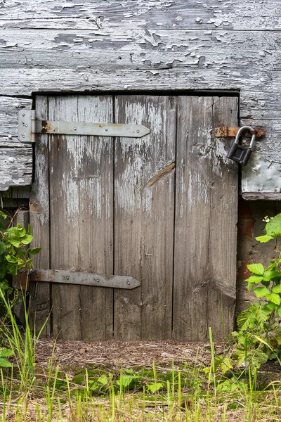 Old wooden door closed on the lock. Rural landscape. — Φωτογραφία Αρχείου