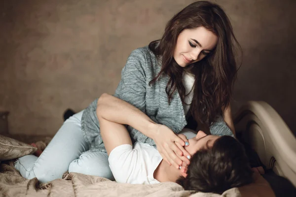 Beautiful brunette girl and guy lying — Stock Photo, Image