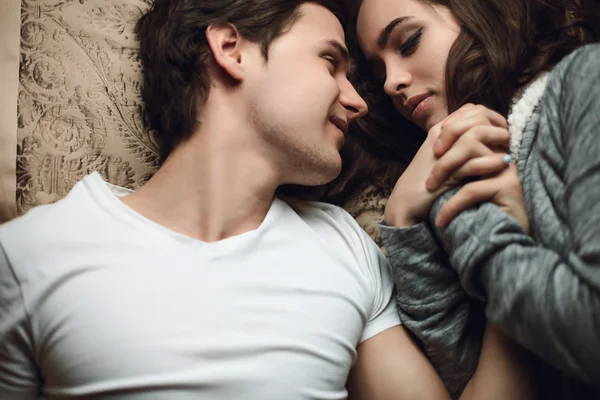 Beautiful brunette girl and guy lying — Stock Photo, Image