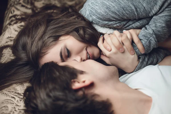 Beautiful brunette girl and guy lying — Stock Photo, Image