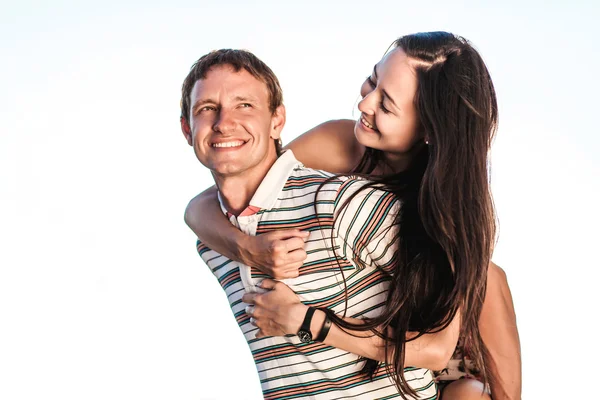 The boy rolls the girl on him back — Stock Photo, Image