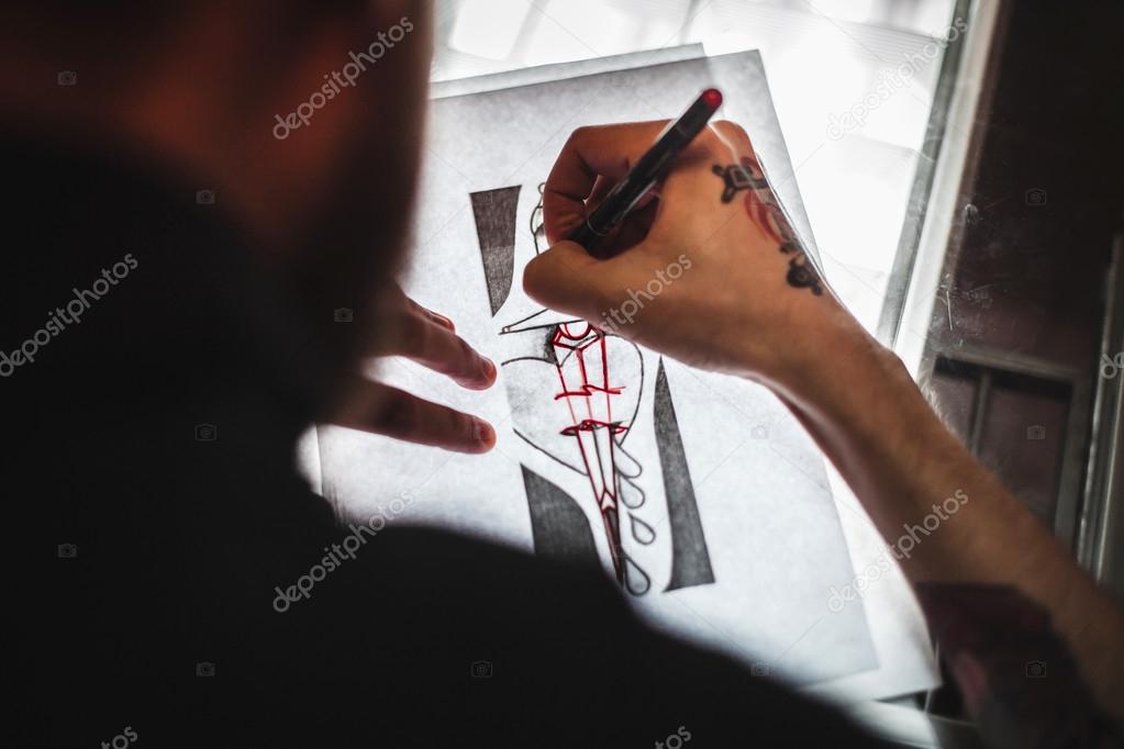 Master tattoo artist prepares the transfer