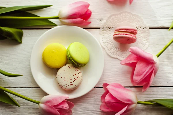 Een mooie roze tulpen met kleurrijke bitterkoekjes — Stockfoto