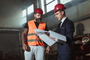 Yönetmen takım elbise ve kask ve tulum işçi