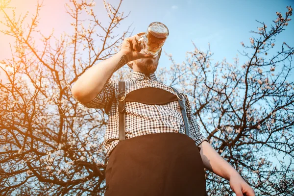 Feliz hombre sonriente degustación de cerveza recién hecha —  Fotos de Stock