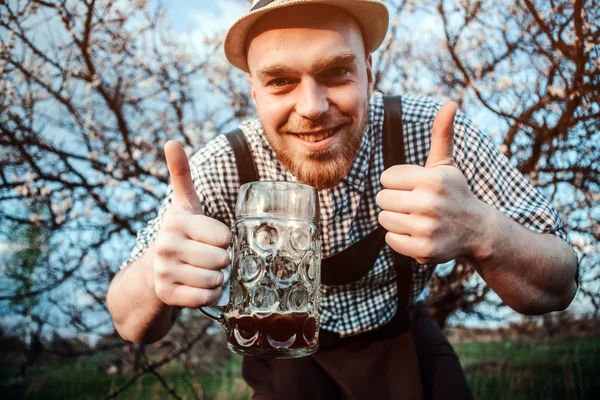 Happy smiling man tasting fresh brewed beer
