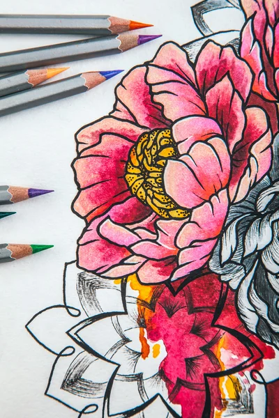 beautiful sketch drawing with colored pencils lying on old wooden background