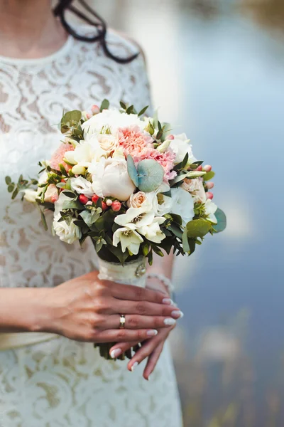 Beautiful and original bouquet of flowers in the hands of the girls — Stock Photo, Image