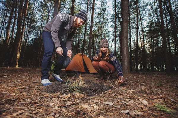 Hikers starting a fire in the wood — Stock Photo, Image