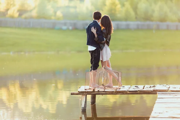 Happy romantic couple rowing a small boat on lake — Stock Photo, Image