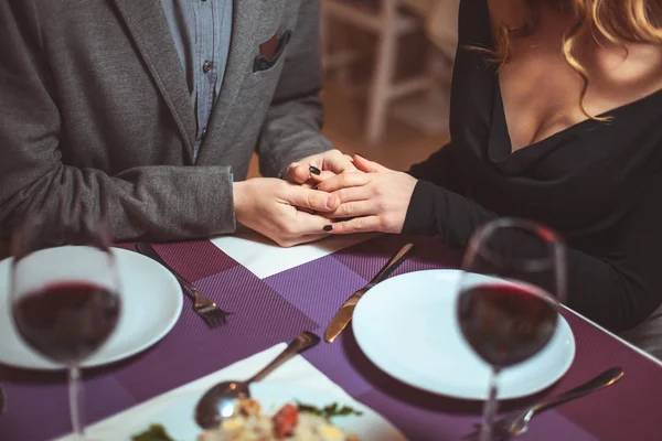 Schönes junges Paar mit Gläsern Rotwein im Luxusrestaurant — Stockfoto