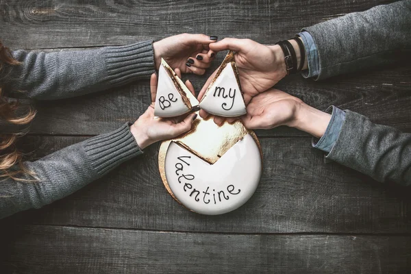 Prachtige taart voor Valentijnsdag in de handen van een verliefde paar — Stockfoto