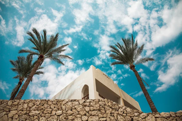 Роскошный египетский отель с пальмами и голубым небом — стоковое фото