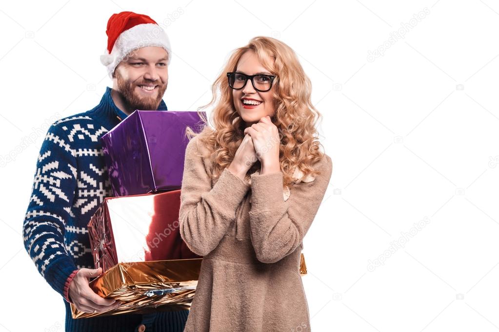 Beautiful couple having fun in hat Santa with champagn
