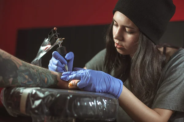 Vacker brunett flicka gör tatuering — Stockfoto