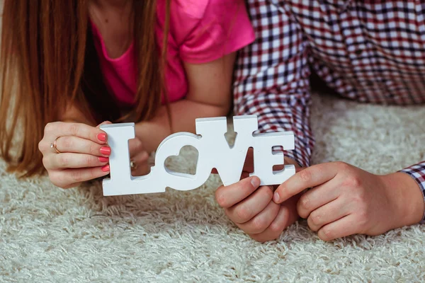 The guy and the girl holding the word — Stock Photo, Image