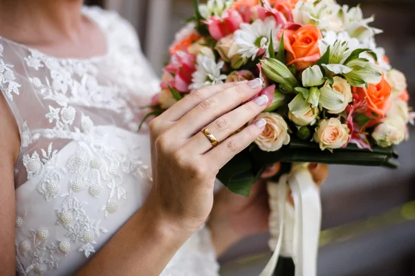 Beautiful wedding bouquet in hands of the bride Stock Photo