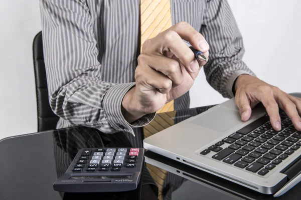 Businessman analyzing investment charts with laptop. Accounting