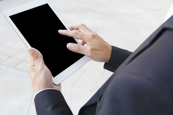 Business man using a variety of mobile devices, mobile phones, smart watches, tablet, computer