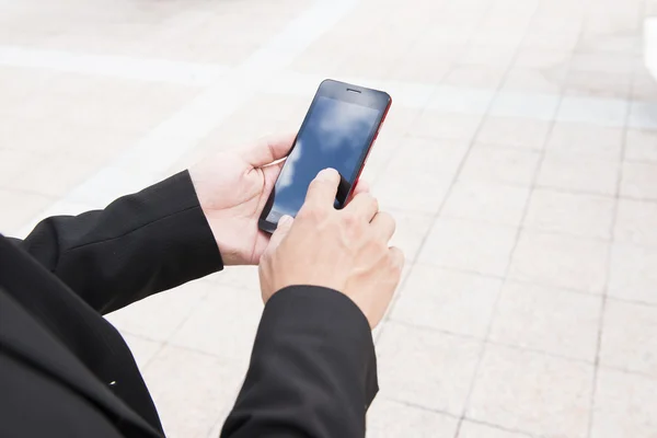 Business man using a variety of mobile devices, mobile phones, smart watches, tablet, computer