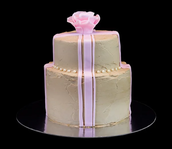 Un pastel beige con una rosa rosa — Foto de Stock