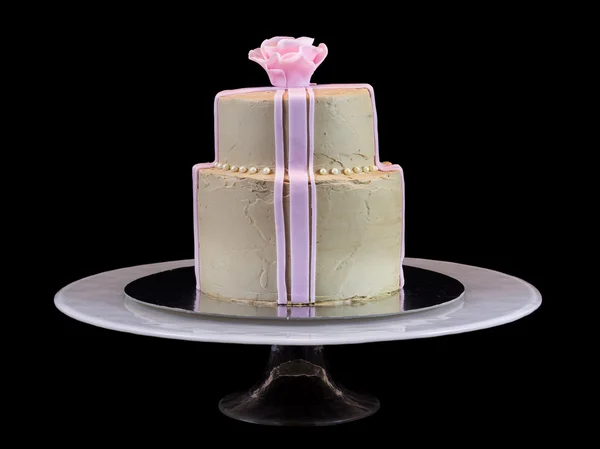 Un pastel beige con una rosa rosa — Foto de Stock