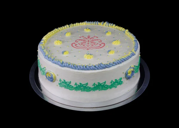 Un pastel blanco con decoraciones en diferentes colores — Foto de Stock