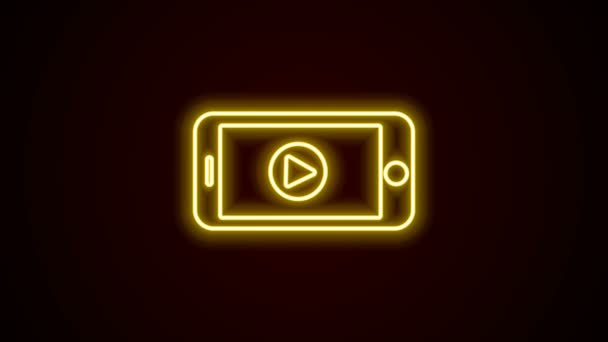 글로잉 네온 온라인 플레이 비디오 아이콘검은 배경에서 분리. 스마트 폰 과 필름 스트립에 플레이사인 이 있습니다. 4K 비디오 모션 그래픽 애니메이션 — 비디오