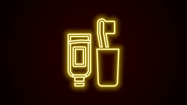 Gloeiende neon lijn Tandenborstel en tube tandpasta icoon geïsoleerd op zwarte achtergrond. Wegwerpbadkamerbenodigdheden. 4K Video motion grafische animatie — Stockvideo