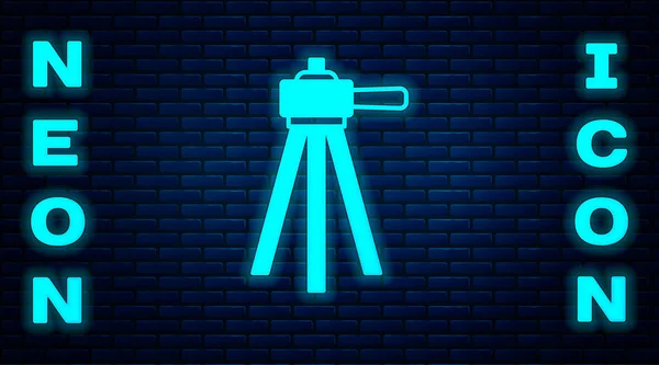 Parlayan Neon Tripod Simgesi Tuğla Duvar Arka Planında Izole Edilmiş — Stok Vektör