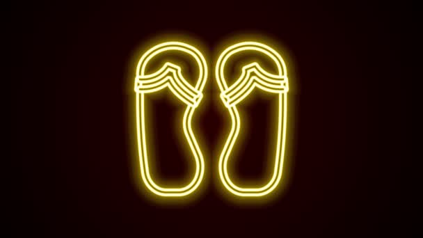 Glowing neon line Flip flops icon isolated on black background. Beach slippers sign. 4K Video motion graphic animation — Stock Video