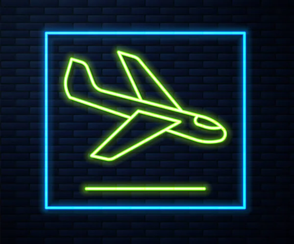 Gloeiende neon lijn Vliegtuig landing pictogram geïsoleerd op baksteen muur achtergrond. Vliegtuigtransportsymbool. Vector — Stockvector