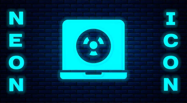 Glowing neon Nuclear laptop icon isolated on brick wall background. Vector — Stock Vector
