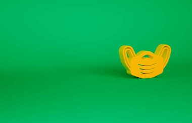 Turuncu tıbbi maske ikonu yeşil arka planda izole edildi. Minimalizm kavramı. 3d illüstrasyon 3B canlandırma
