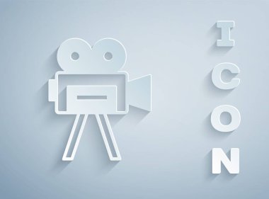 Kağıt kesiği, gri arkaplanda izole edilmiş Retro sinema kamerası ikonu. Video kamera. Film tabelası. Film projektörü. Kağıt sanatı tarzı. Vektör