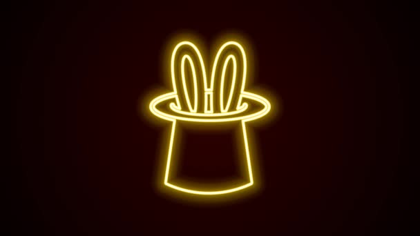Linha de néon brilhante Ícone de chapéu mágico e orelhas de coelho isolado no fundo preto. Truque mágico. Conceito de entretenimento misterioso. Animação gráfica em movimento de vídeo 4K — Vídeo de Stock
