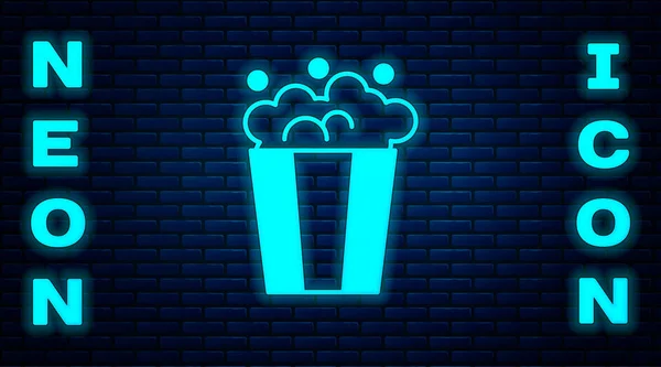 Glowing neon Popcorn in cardboard box icon isolated on brick wall background. Popcorn bucket box. Vector — Stock Vector