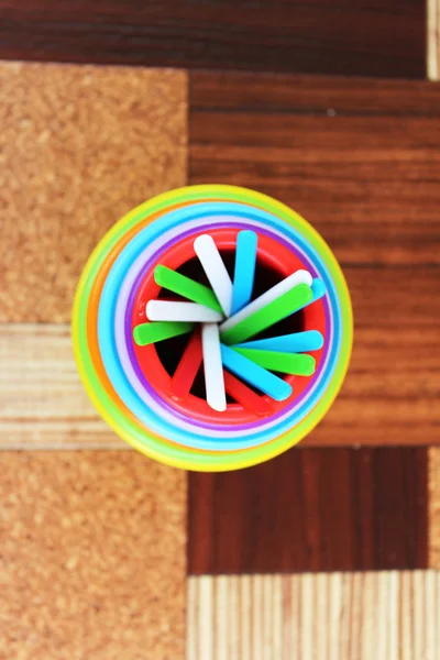 Colorful plastic sticks in plastic cups — Stock Photo, Image