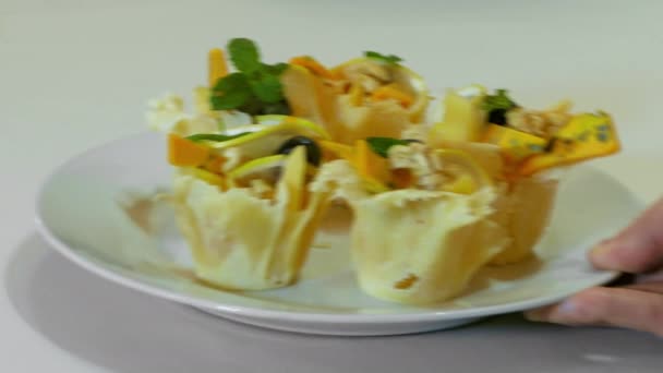 Waiter Puts A Plate With Tartlets On The Table — Stock Footage Waiter Puts A Plate With Tartlets On The Table Royalty Free Stock Footage