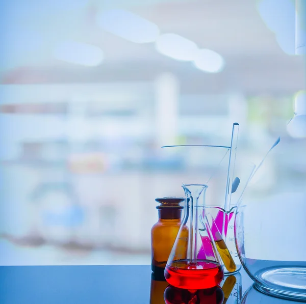 Glassware with blur laboratory in background. — Stock Photo, Image