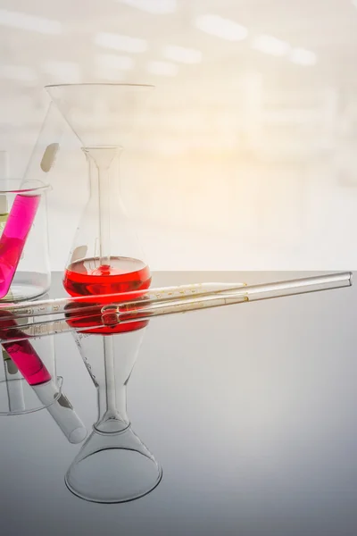 Glassware with blur laboratory in background. — Stock Photo, Image