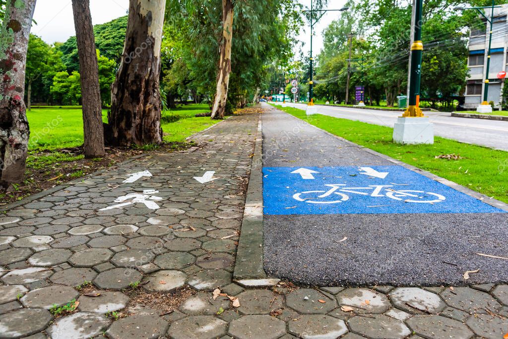 Image of asphalt road and new  wa;k and bike lane with sign for background usage.