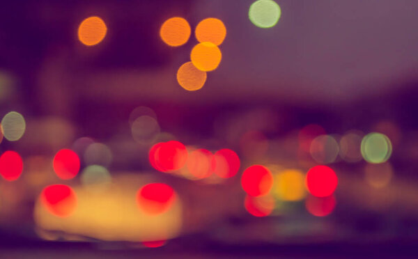 Vintage tone blur image of inside cars with bokeh lights from traffic jam on night time for background.