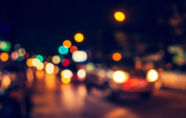 vintage tone image of blur street bokeh with colorful lights in night time for background usage .