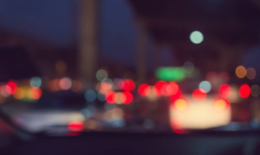 Arka plan için gece vakti trafik sıkışıklığından gelen bokeh ışıkları olan içerideki arabaların klasik ton bulanık görüntüsü.