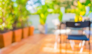 Arka plan kullanımı için yeşil ağaç bokeh ile gündüz vakti bulanık bir restoran görüntüsü .