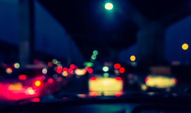 Arka plan için gece vakti trafik sıkışıklığından gelen bokeh ışıkları olan içerideki arabaların klasik ton bulanık görüntüsü.